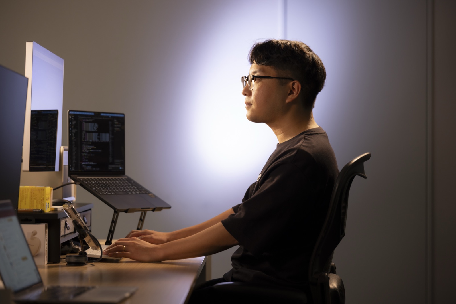 デスクでキーボードを打つ李さんの横顔